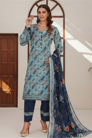 Woman wearing a blue floral traditional outfit with a matching dupatta in a well-lit room.
